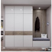 Modern built-in cabinets with white doors and a wooden finish, featuring a bench and coat hooks.