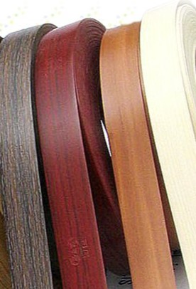 Various colors of edge banding strips in different wood finishes.