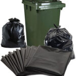 Black Trash Bags and Green Garbage Bin