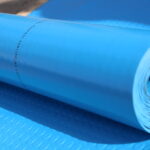 Electrical Insulating Mat. -A roll of blue electrical insulating mat, designed to provide high-voltage insulation and safety, displayed on a flat surface.