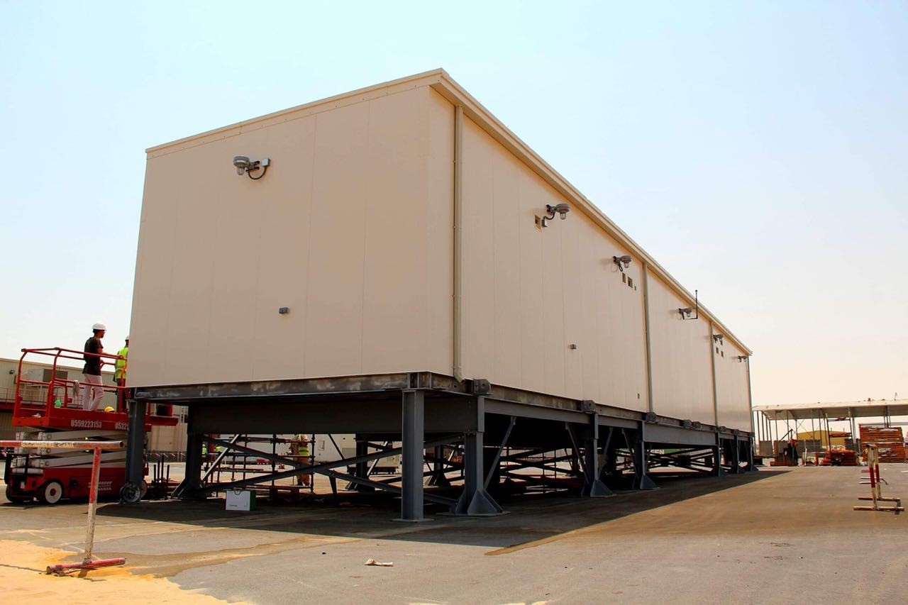 A large prefabricated substation (E-House) by Eaton Arabia, elevated on a platform, designed for oil, gas, and petrochemical applications.
